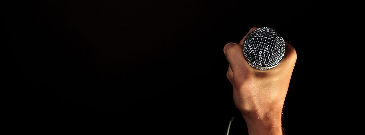 holding a microphone music lessons